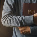 man holding bible in hands