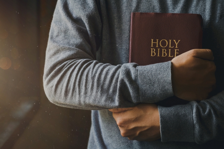 man holding bible in hands