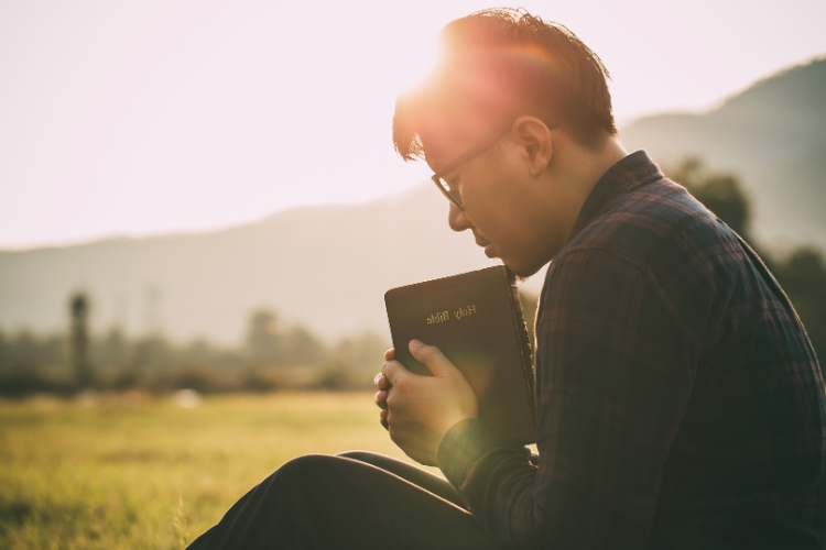 Man holding holy bible book