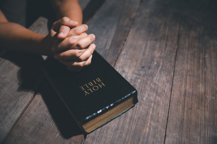 holly bible on wooden texture table